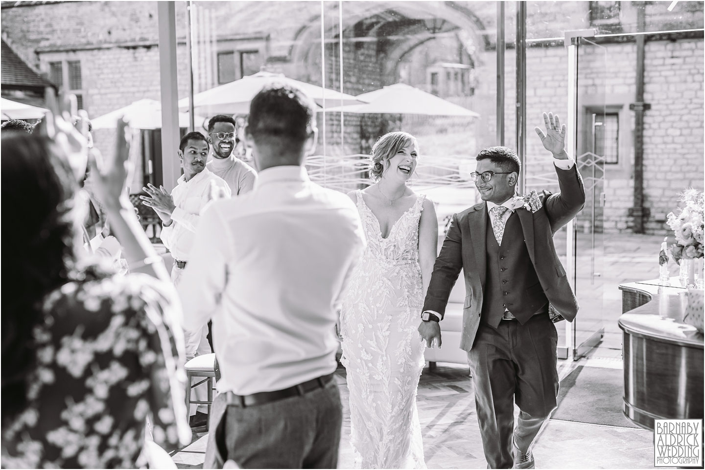 Candid photos of the entrance of the bride and groom at Thornbridge Hall by Yorkshire Wedding Photographer Barnaby Aldrick