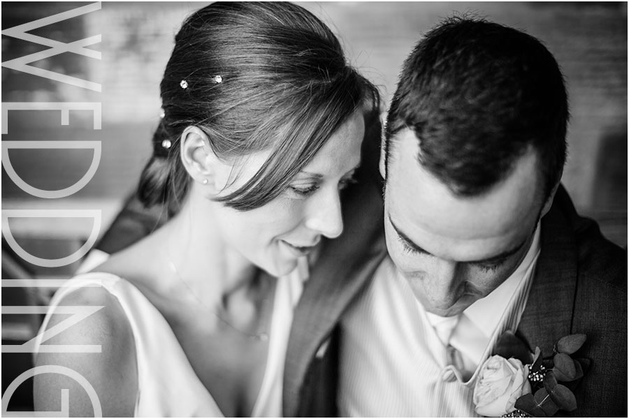 A relaxed romantic wedding photo of a bride and groom cuddling at their country house wedding venue Rudding Park hotel and spa near Harrogate in Yorkshire