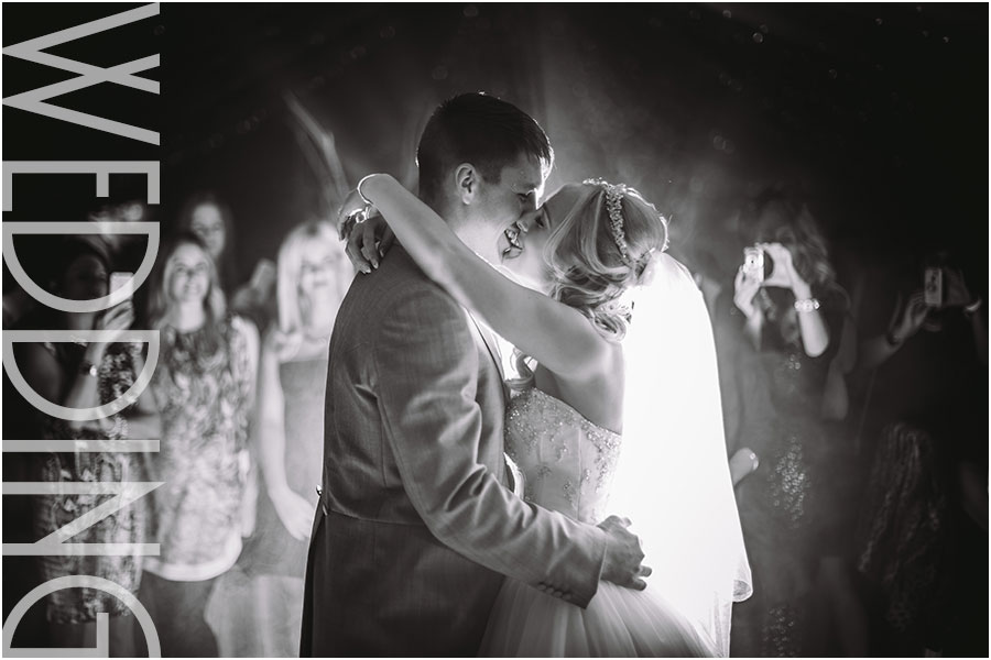A couple kiss during first dance at their wedding at Woodlands Hotel in Gildersome near Leeds in West Yorkshire
