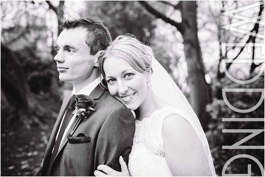A black and white relaxed wedding photo of a bride and groom at Woodlands Hotel in Gildersome near Leeds in West Yorkshire