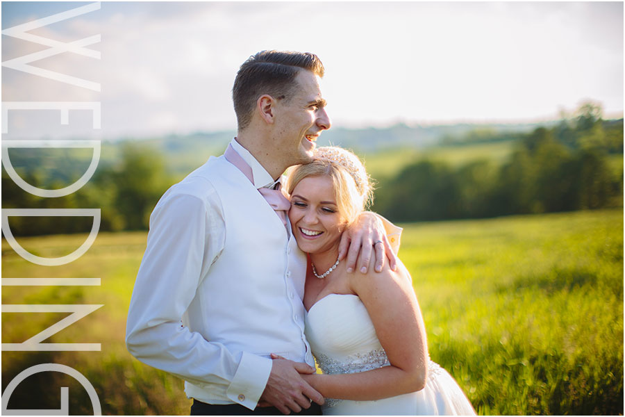 A relaxed wedding couple laugh during golden hour photos at their wedding at Shottle Hall in Derbyshire
