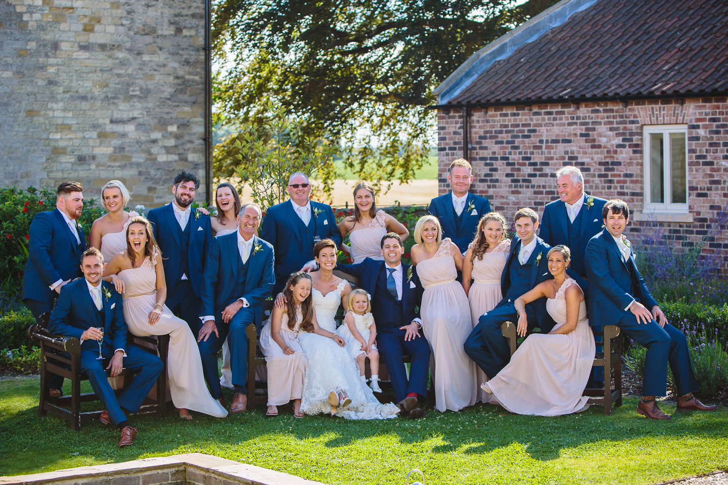A wedding photograph of a fun & funky groupshot at Priory Cottages wedding venue near Tadcaster and Wetherby in Yorkshire