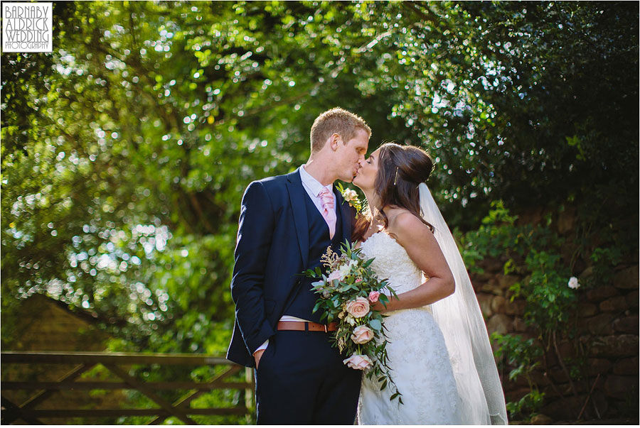 A newly wed couple kiss at their wedding at Blackbrook House in Belper in Derbyshire