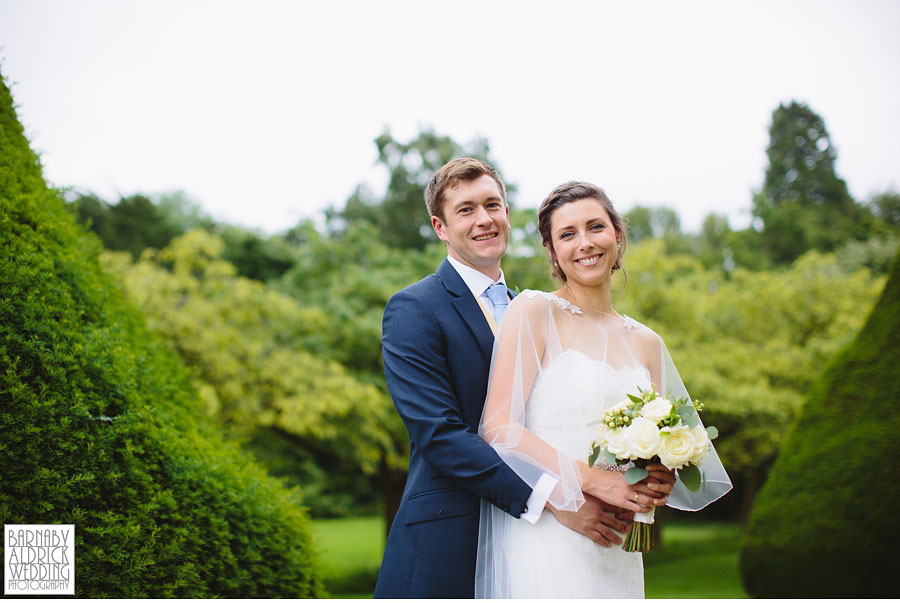 A beautiful bride and handsome groom pose for portraits in the grounds of the North York Moors wedding venue Newburgh Priory