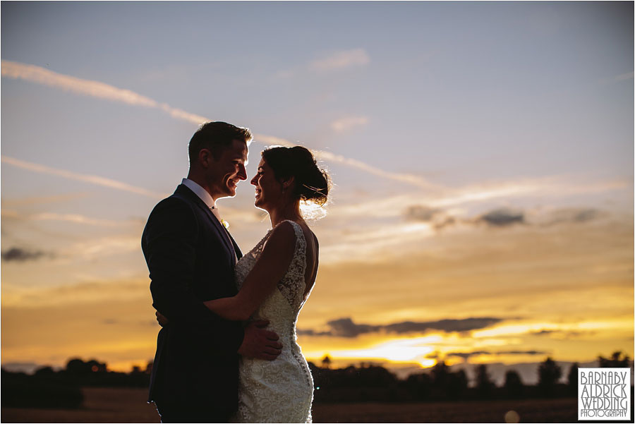 An evening portrait of a beautiful bride and groom laughing at Sunset at Priory Cottages wedding barn venue between Tadcaster and Wetherby