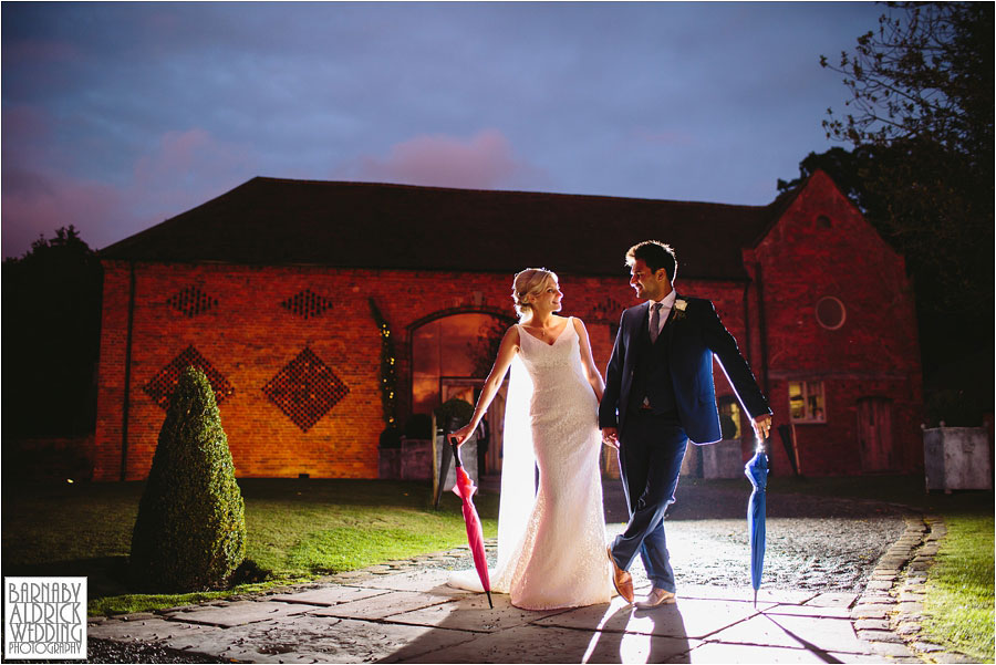 A bride and groom pose for fun evening flash portraits at Cripps Shustoke Farm Barns Wedding venue near Solihull and Birmingham in the East Midlands
