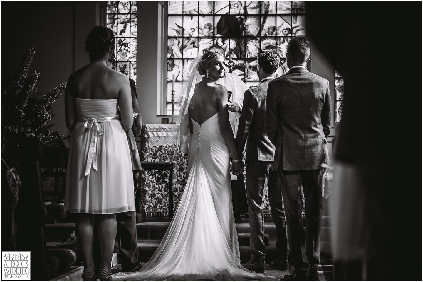 A photo of bride during the service at St Helen's Church at Denton Hall in Yorkshire