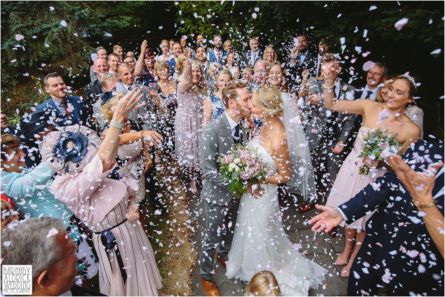 A Wedding photo of the confetti being thrown at St Helen's Church at Denton Hall in Yorkshire