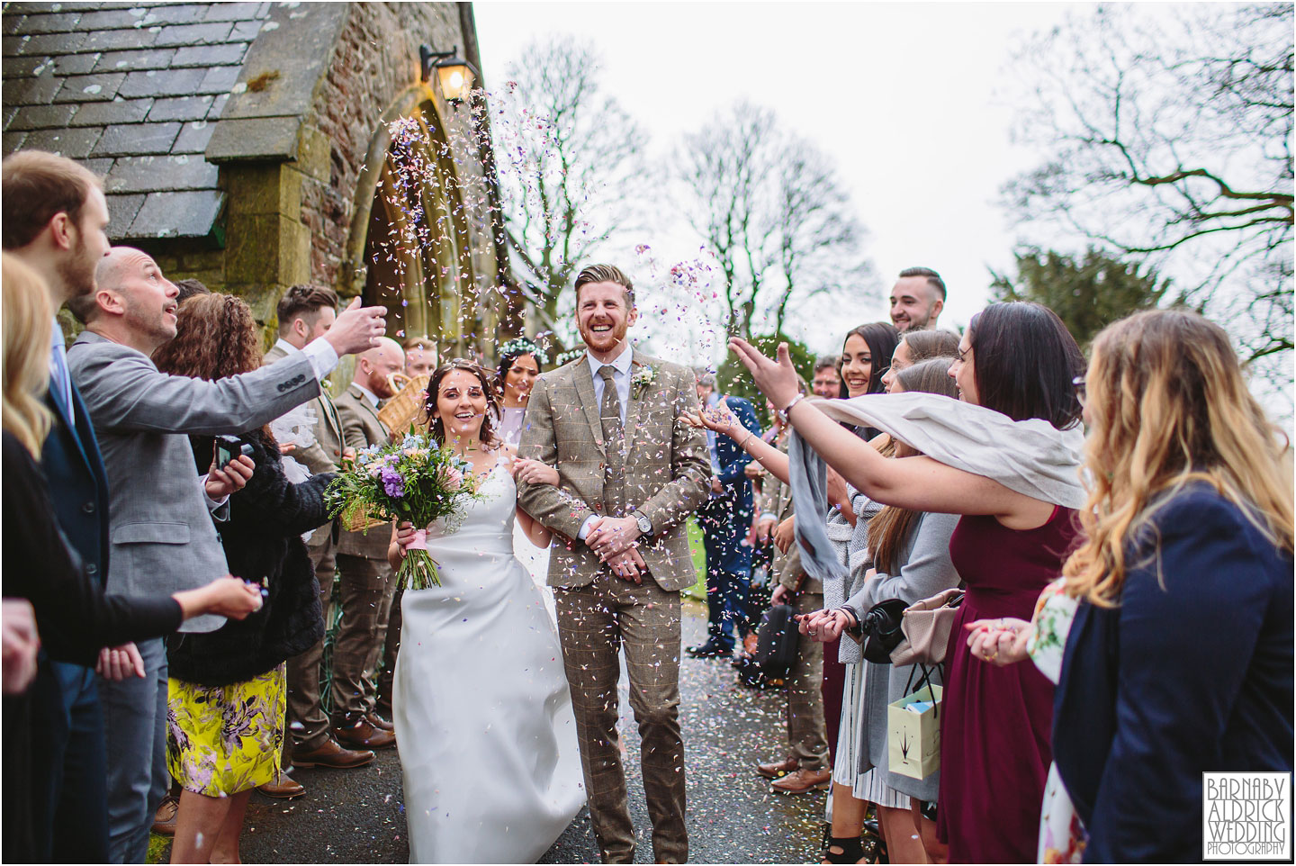 Confetti wedding photograph of a happy couple at Falcon Manor in Settle, Church confetti photo settle, Yorkshire Dales Wedding Photographs