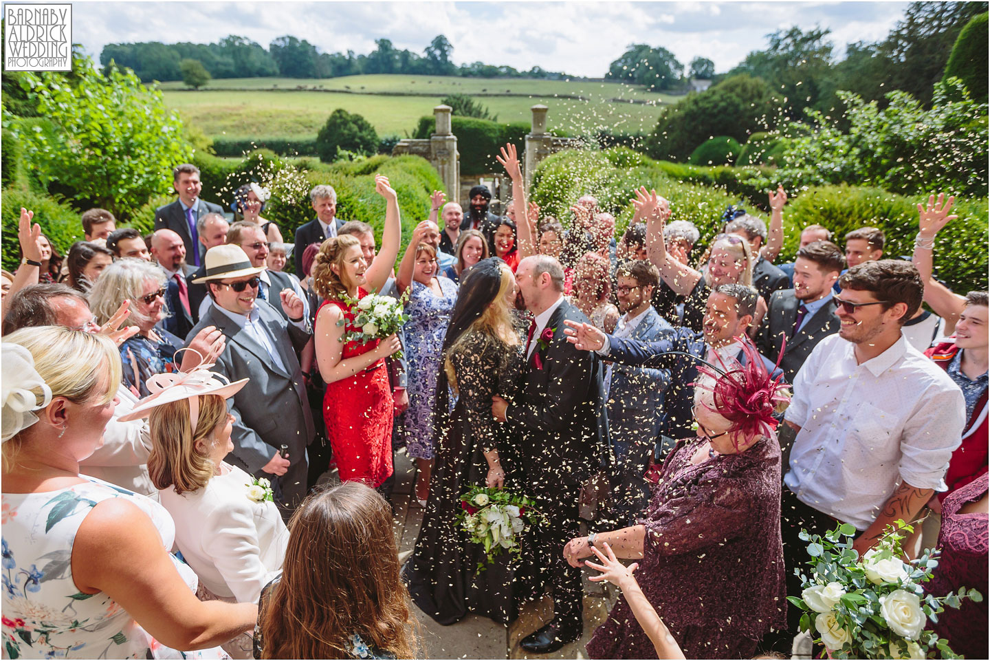 A wedding photo at Fountains Abbey of a confetti throw