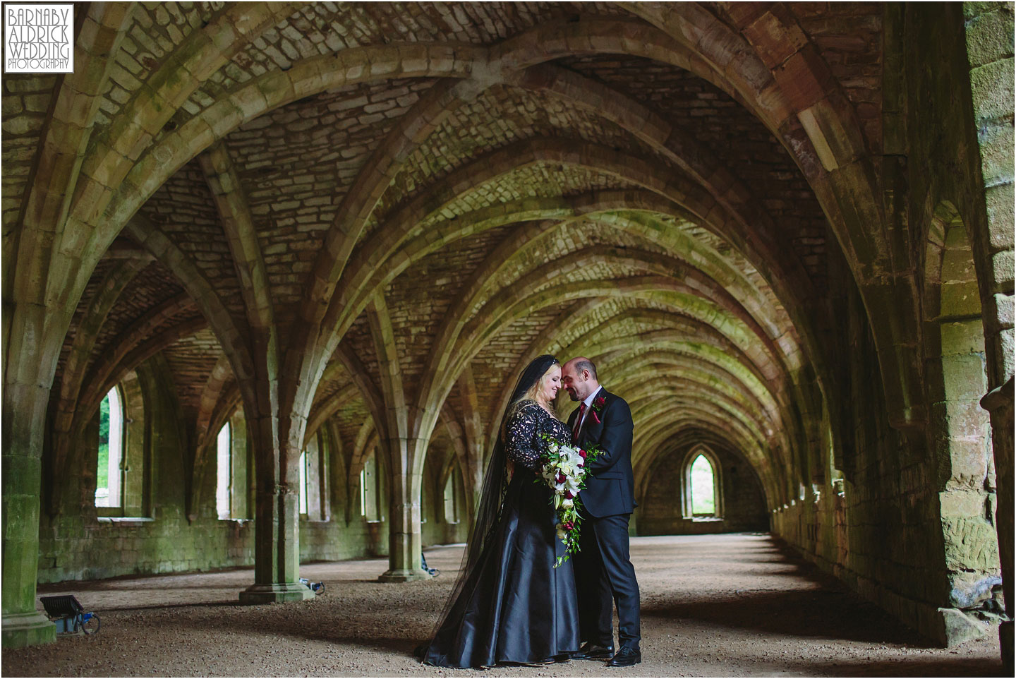 A wedding portrait photo in the cellarium of The National Trust's Fountains Abbey