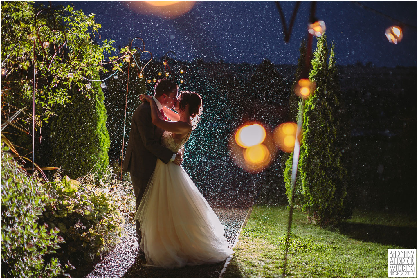 Backlit rain wedding photograph at Yorkshire Wedding Barn near Richmond in Yorkshire