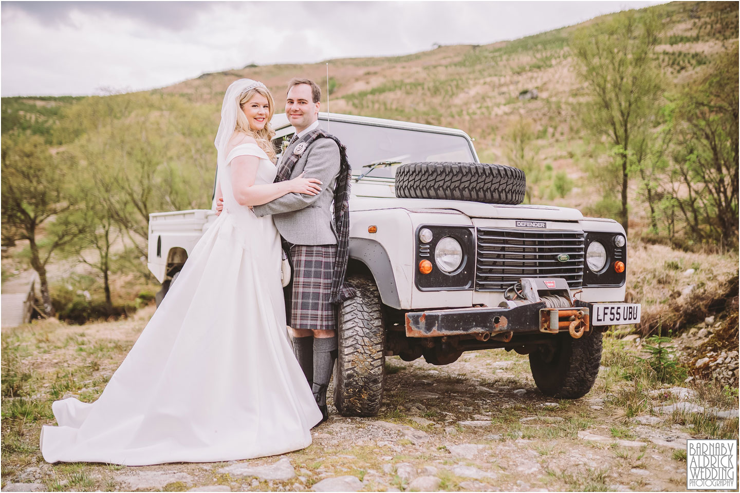 Wedding photographer with Landrover discovery on the Castle Carrick estate in Scotland