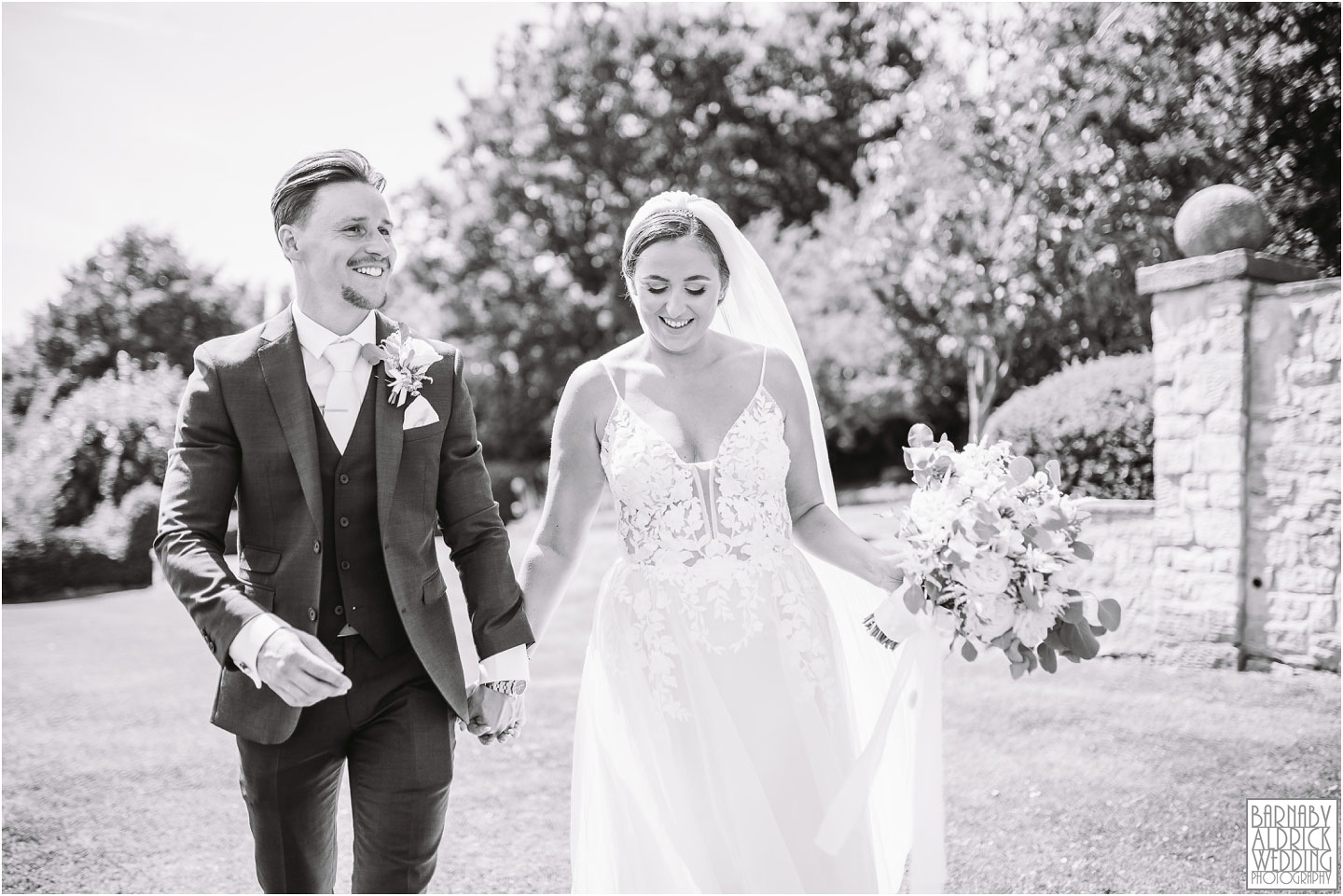 A relaxed bride and groom walk through the grounds of Wood Hall near Wetherby in Yorkshire